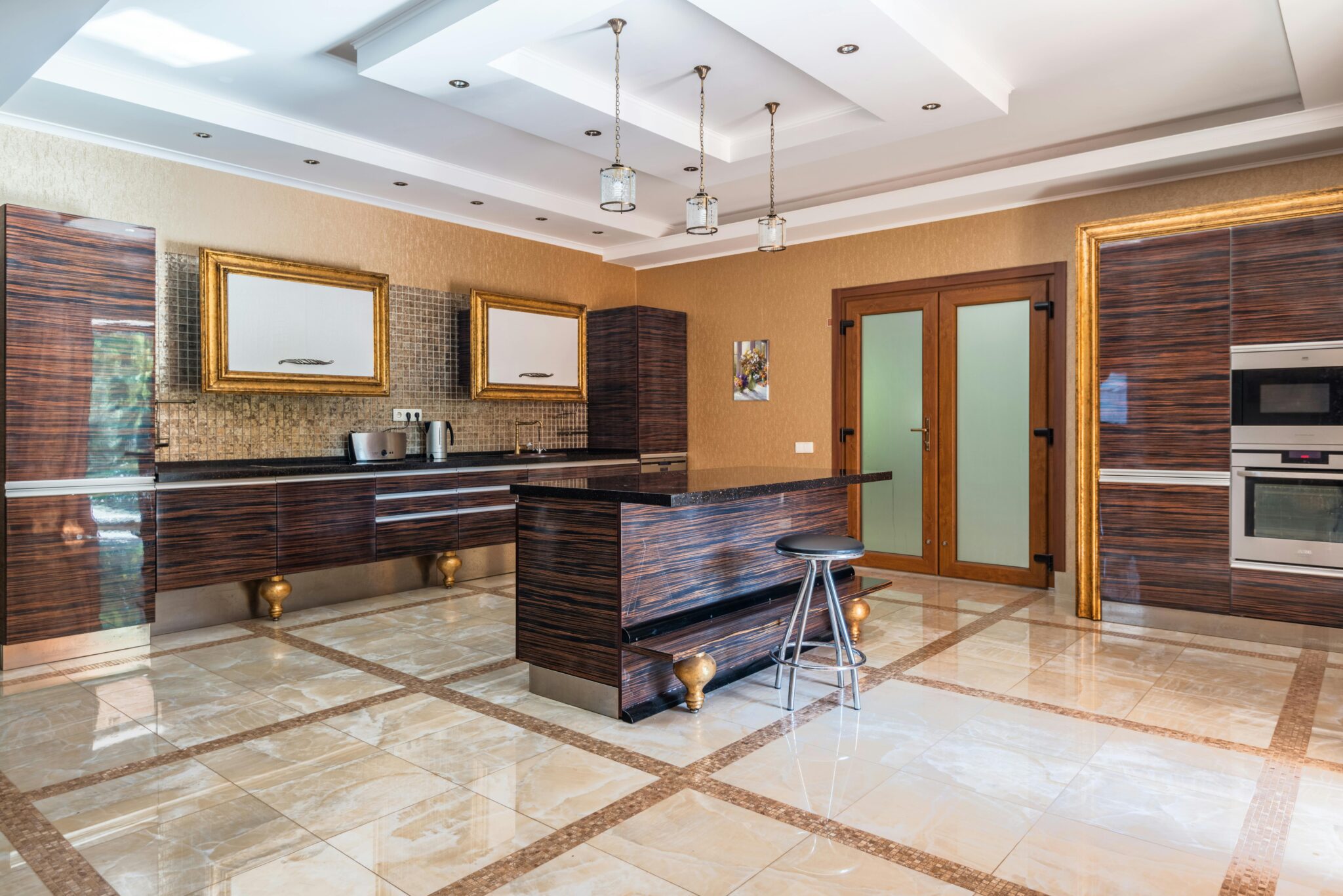 A luxurious and spacious kitchen featuring modern wood cabinetry and elegant lighting.