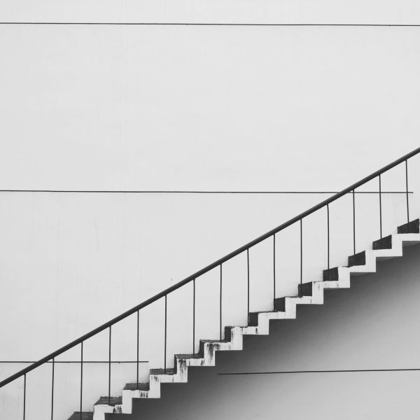 Minimalistic black and white staircase with sharp angles and clean lines, showcasing modern architecture.