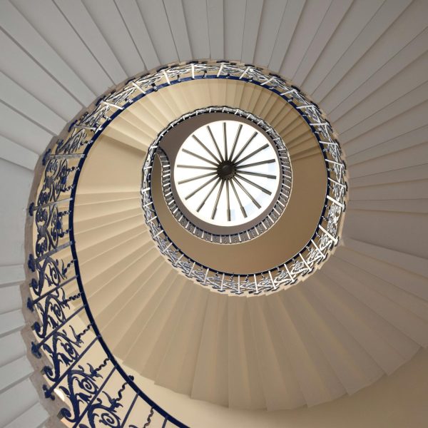 A captivating view up a spiral staircase with intricate railing design.